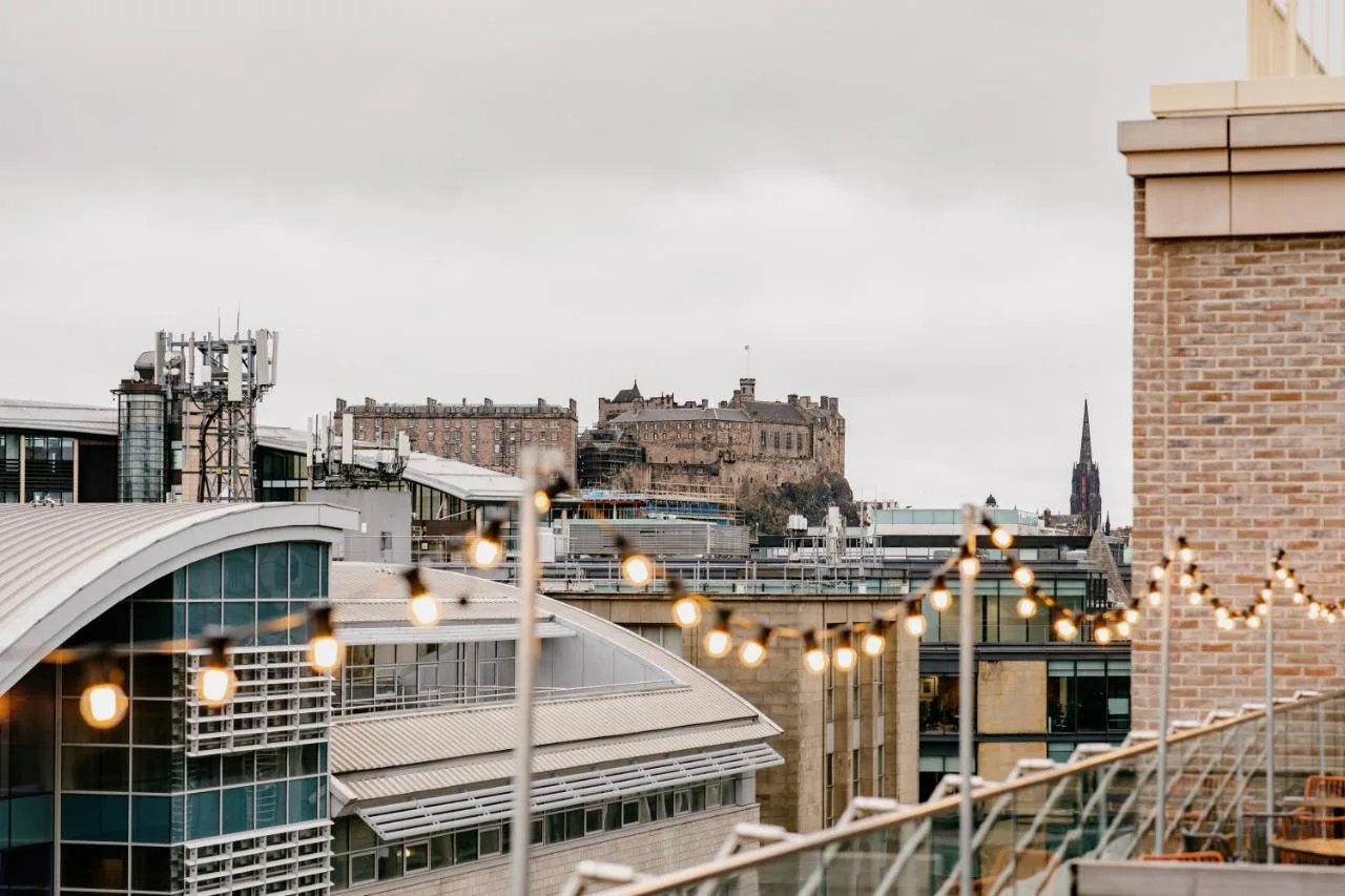 a view of a city from a rooftop with lights at Moxy Edinburgh in Edinburgh